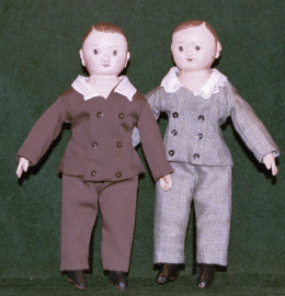 Two Sweet little boy dolls in suits